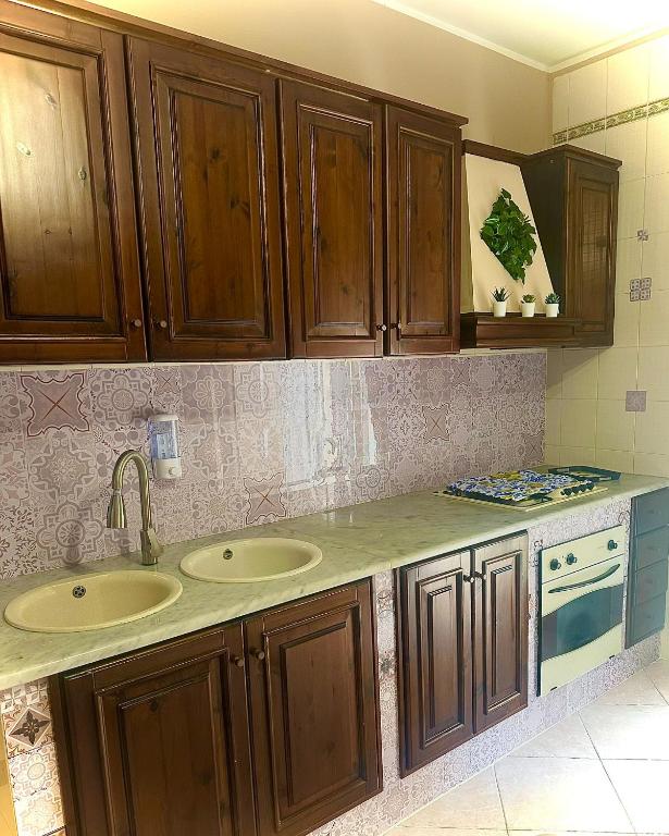 Cucina attrezzata con pensili in legno e piano di lavoro